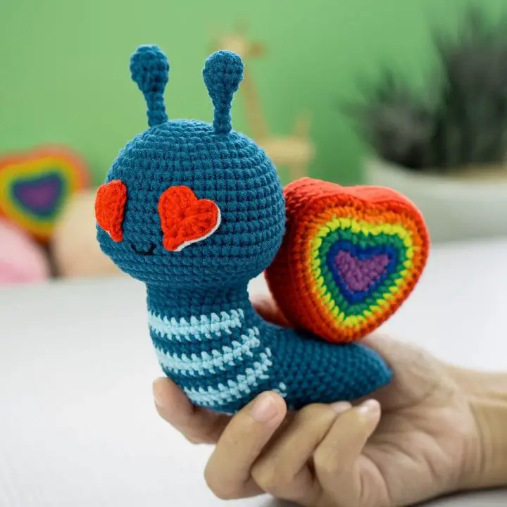 Rainbow Heart crochet snail carries rainbow heart